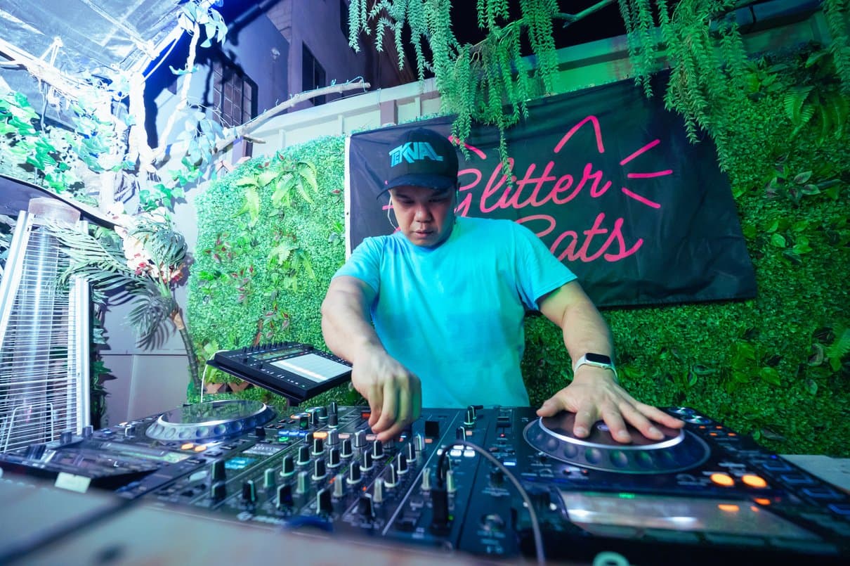 TEKNAL behind the decks under stage lights